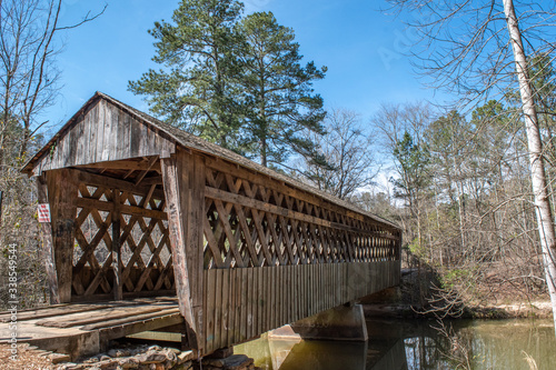 Covered bridge in countryside with blue sky background. © Kathryn