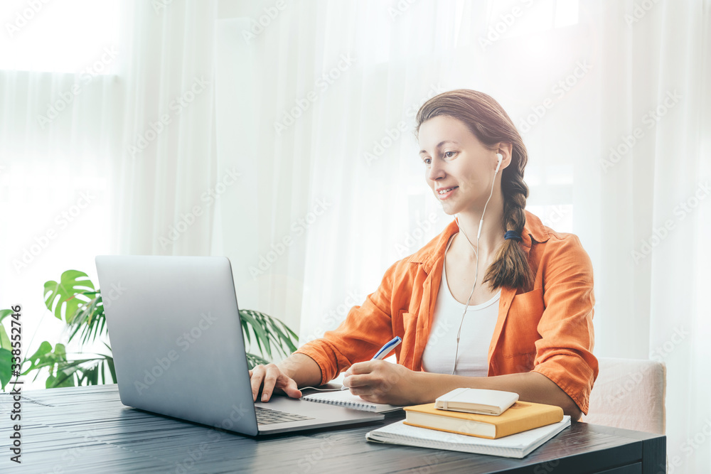 Woman sits in front of lap top. Woman sits in front of lap top.