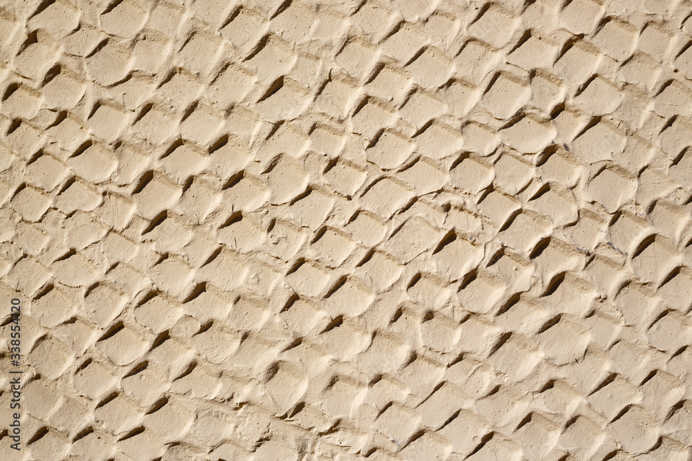 The texture of the plastered wall. Rough corrugated cement surface. Uneven angular pattern. Perfect for background and design.