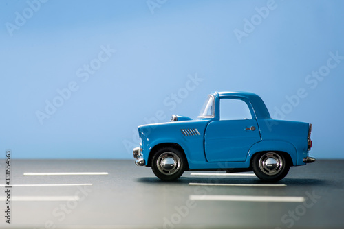 Blue toy car on a blue background.