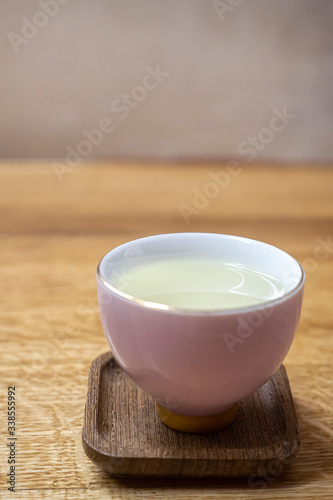 White checker with green tea. Tea Cheremonia. Wooden table