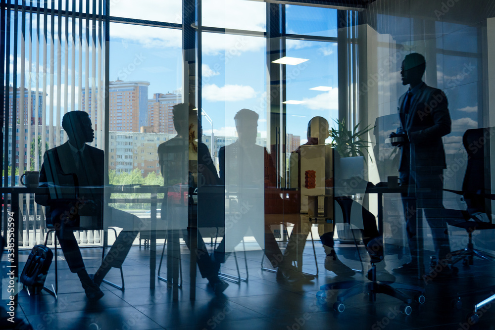 boss afro businessmen talking with arab partners colleague, multiethnic team in the office with panorama window. boss afro businessmen talking with arab partners colleague, multiethnic team in the office with panorama window.