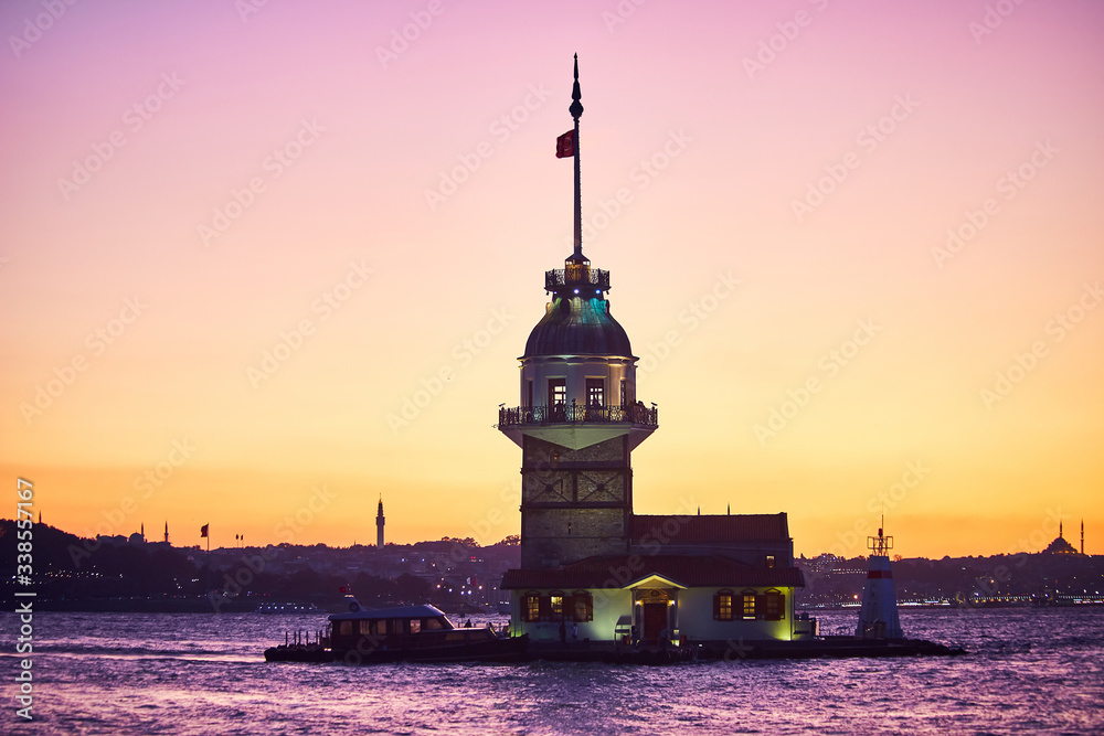 Fiery sunset over Bosphorus with famous Maiden's Tower (Kiz Kulesi in Turkish) also known as Leander's tower, symbol of Istanbul, Turkey