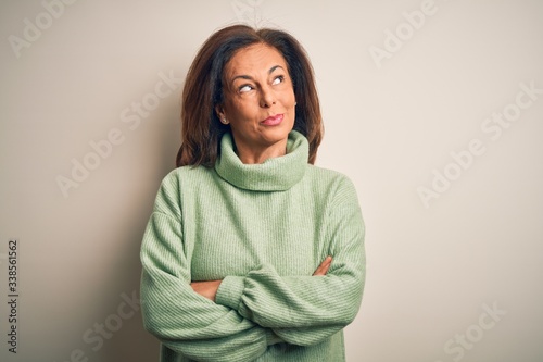 Middle age beautiful woman wearing casual turtleneck sweater over isolated white background smiling looking to the side and staring away thinking. © Krakenimages.com