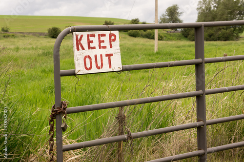 Old keep out sign on fence photo