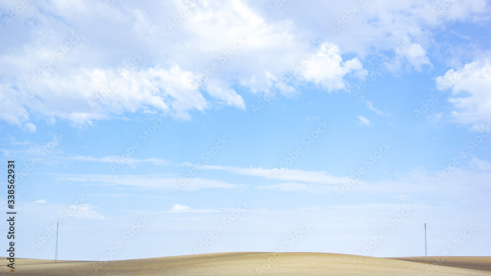 Panoramic view of open field in rural landscape under the blue sky Panoramic view of open field in rural landscape under the blue sky
