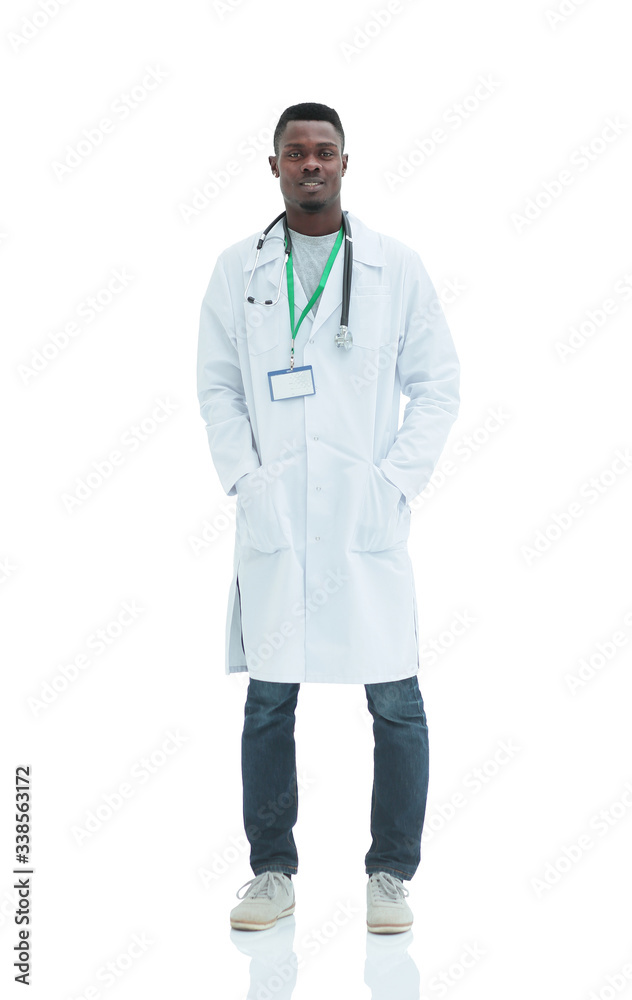 in full growth. a serious doctor in a white coat. in full growth. a serious doctor in a white coat.