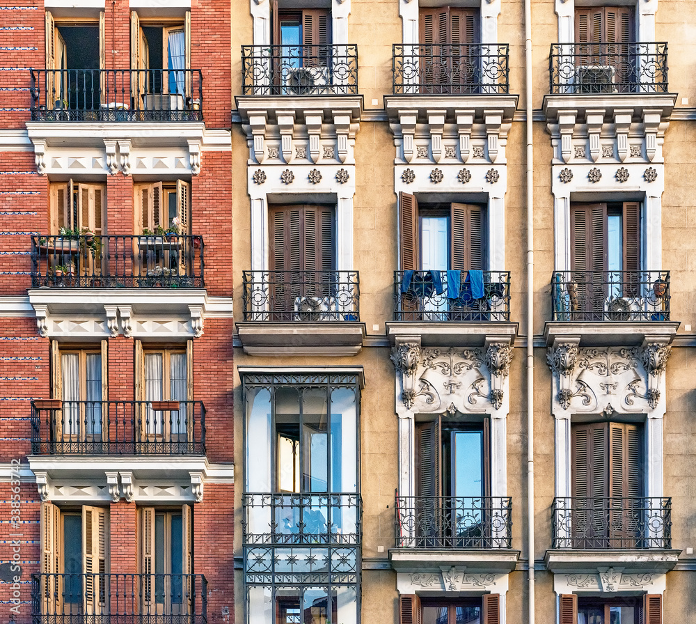 Obraz premium Looking up at building with decorative shuttered balconies