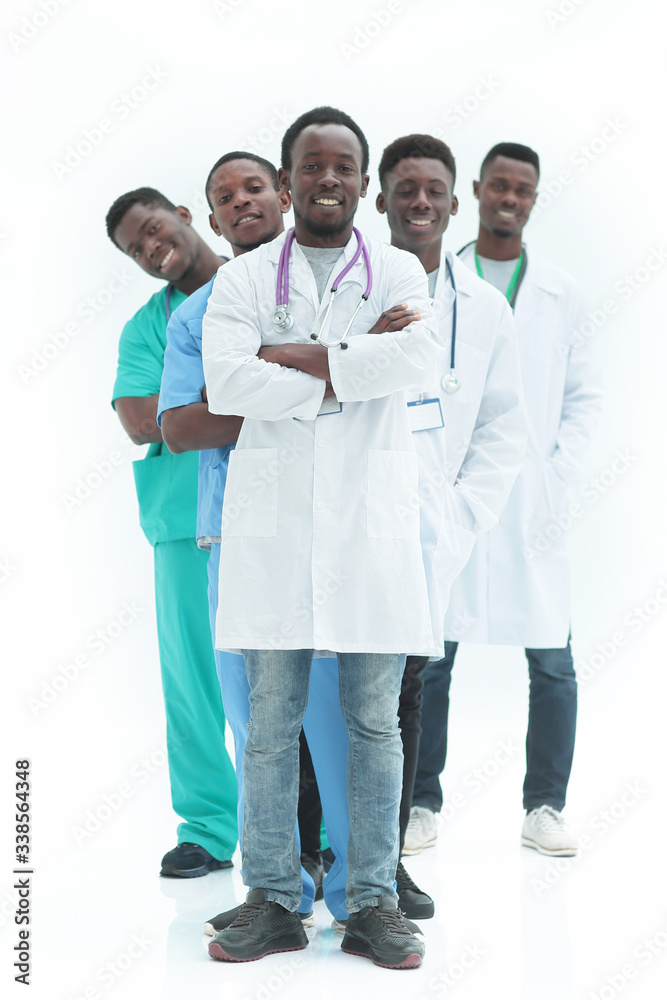 in full growth. smiling young doctors standing one by one in full growth. smiling young doctors standing one by one
