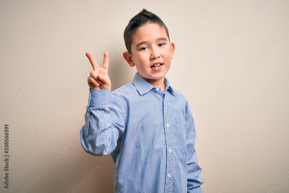 Young little boy kid wearing elegant shirt standing over isolated background showing and pointing up with fingers number two while smiling confident and happy. Young little boy kid wearing elegant shirt standing over isolated background showing and pointing up with fingers number two while smiling confident and happy.