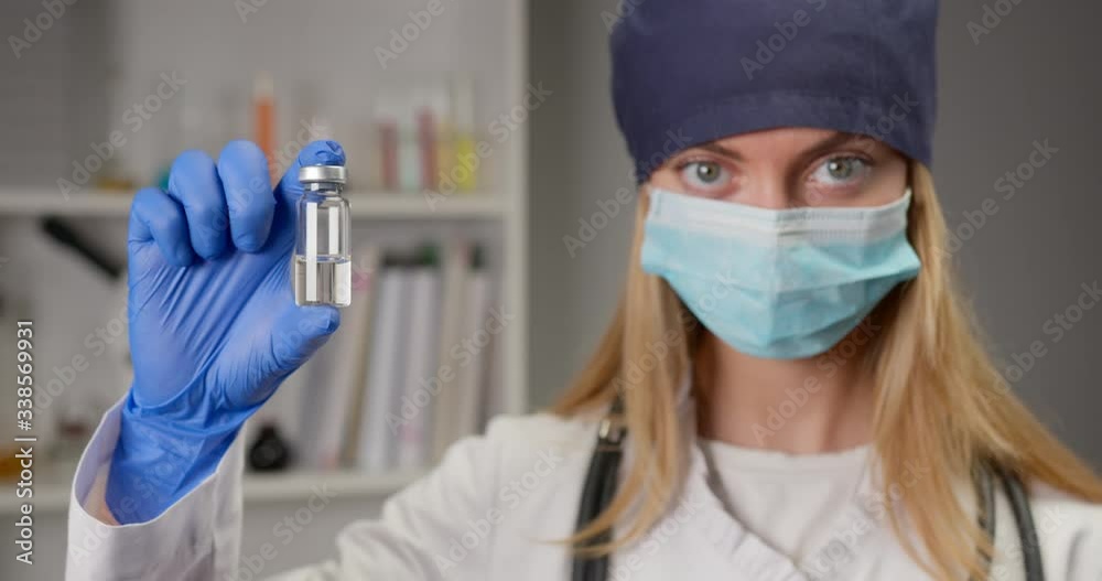 A medical worker is demonstrating a new drug. Research in the laboratory. Look at the camera. 4K A medical worker is demonstrating a new drug. Research in the laboratory. Look at the camera. 4K
