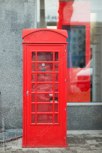 Red telephone box stands on the street