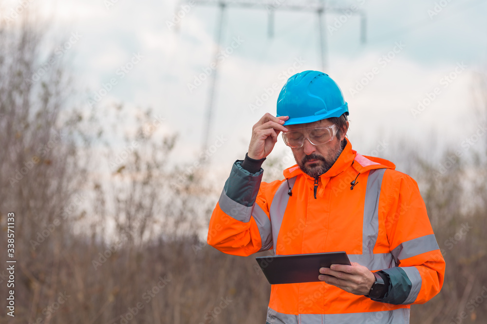 Forestry technician using digital tablet in forest Forestry technician using digital tablet in forest
