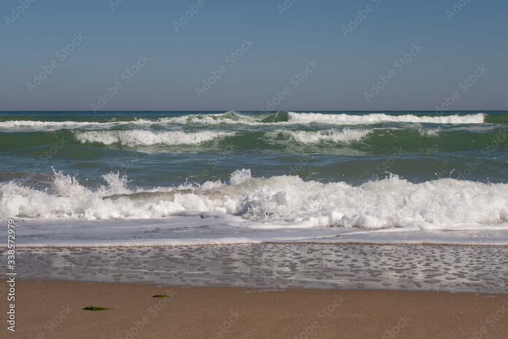 Sea, sea waves and shoreline on a sunny windy day. Sea, sea waves and shoreline on a sunny windy day.