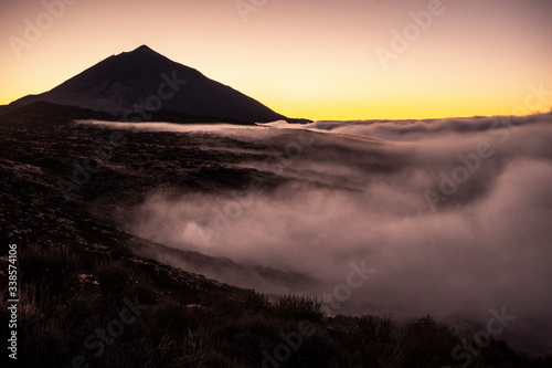 Beautiful misty mountains outdoor natural landscape with high top peak and valley with clouds - weather and storm concept - tenerife el teide vulcan in spain