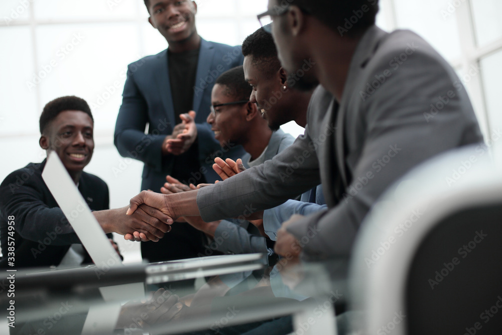 young businessman shaking hands with his business partner young businessman shaking hands with his business partner