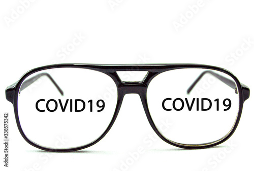 black glasses on a white background with the inscription COVID19 photo