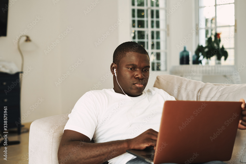 men of african appearance at home in front of a laptop men of african appearance at home in front of a laptop