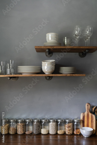 DIY European farmhouse rustic kitchen with gray lime wash wall and floating shelves