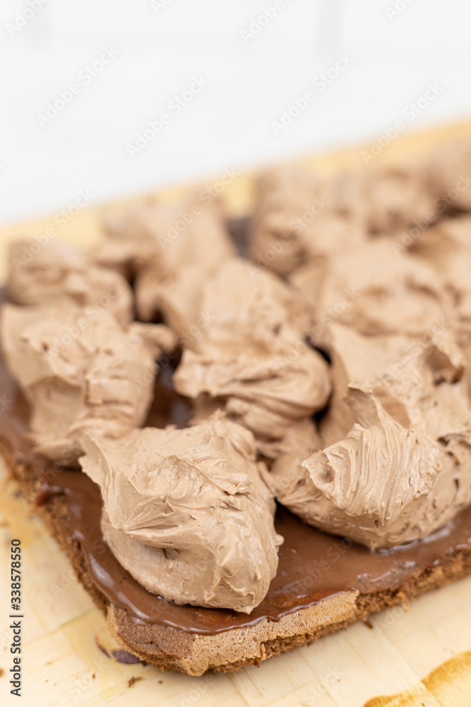 Chocolate cream on the cake. Preparing chocolate cake Chocolate cream on the cake. Preparing chocolate cake