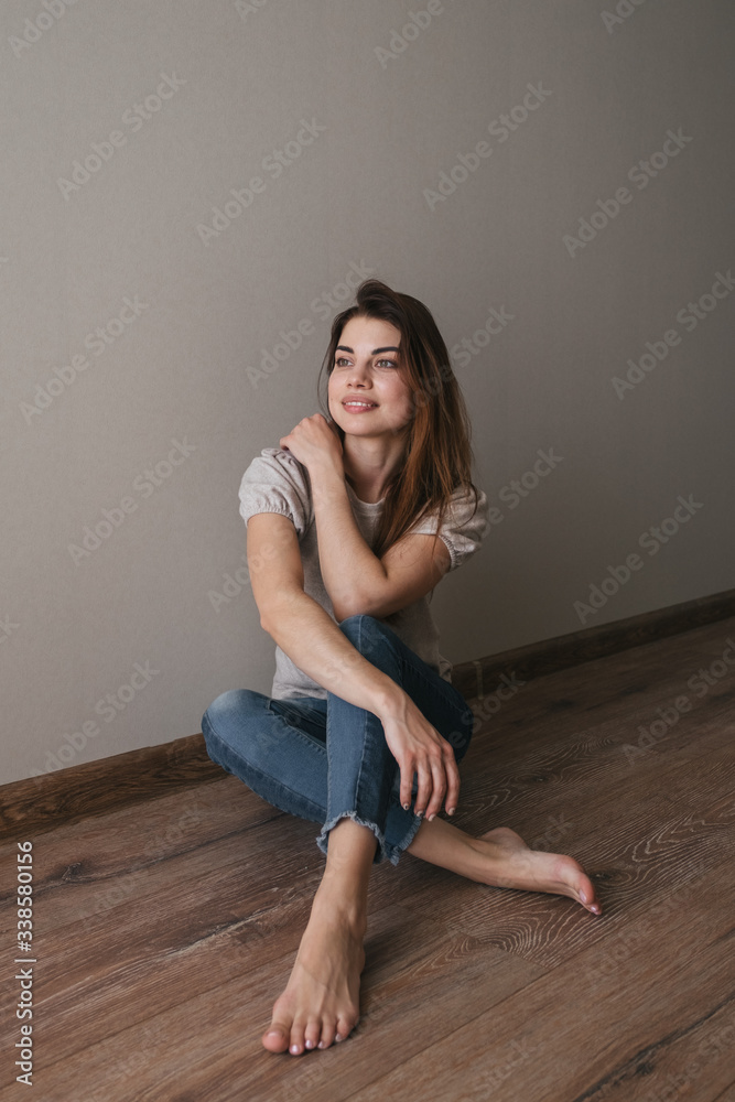 portrait of a beautiful young european brunette girl. sit at home on the floor, relax alone, dream, relax, smile. Good morning, comfort at home, calm. Close up portrait portrait of a beautiful young european brunette girl. sit at home on the floor, relax alone, dream, relax, smile. Good morning, comfort at home, calm. Close up portrait