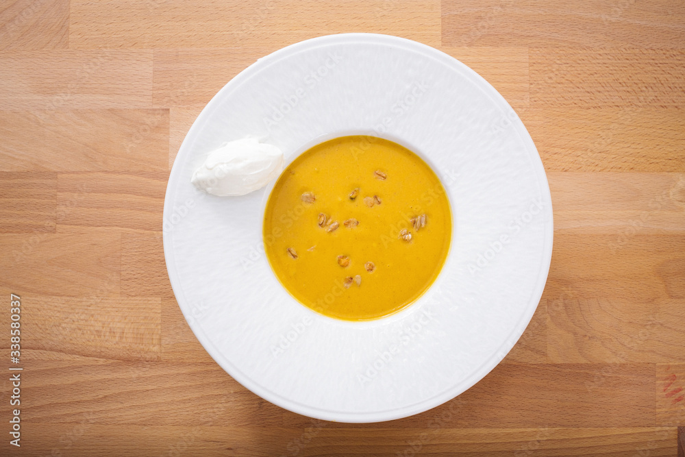 Delicious homemade pumpkin soup with seeds and goat cheese. Perfect for appetizer. Organic Arabic dish perfect for vegan. Healthy food photography. Delicious homemade pumpkin soup with seeds and goat cheese. Perfect for appetizer. Organic Arabic dish perfect for vegan. Healthy food photography.