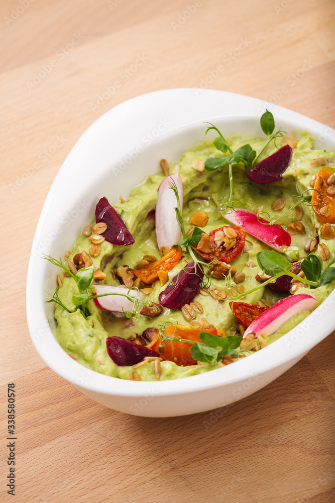 Organic plant based hummus with granola tomato, fresh thymes and rose leaf toppings. Perfect for vegan gluten free. Food photography. Organic plant based hummus with granola tomato, fresh thymes and rose leaf toppings. Perfect for vegan gluten free. Food photography.