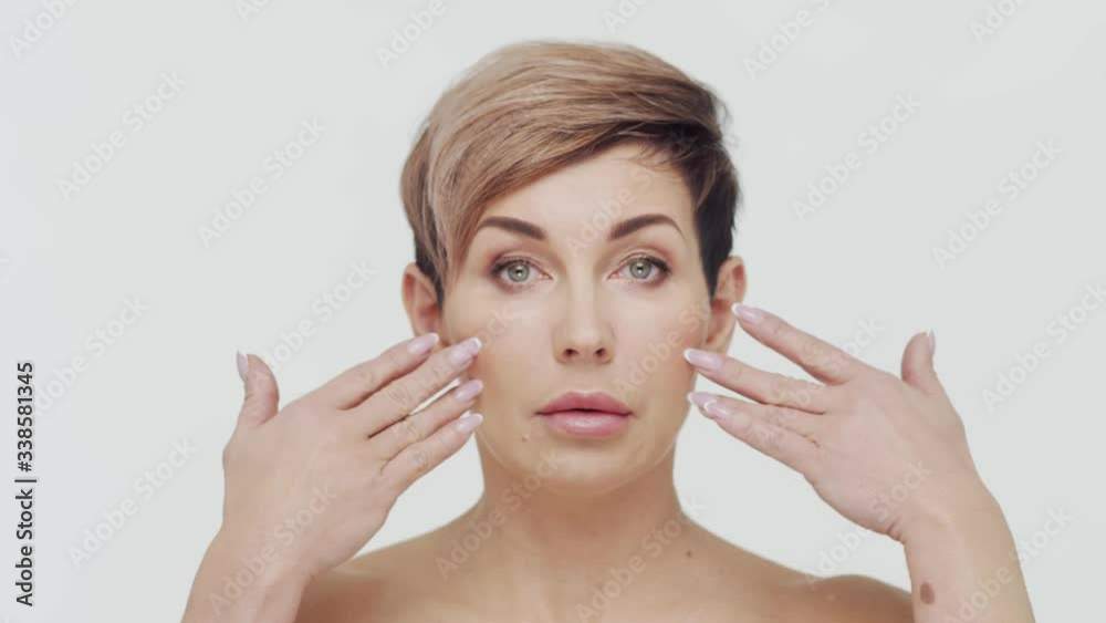 Close-up of middle aged mature woman over white bacjground. Portrait of mature lady. Plastic surgery, beauty injections and cosmetology. Close-up of middle aged mature woman over white bacjground. Portrait of mature lady. Plastic surgery, beauty injections and cosmetology.