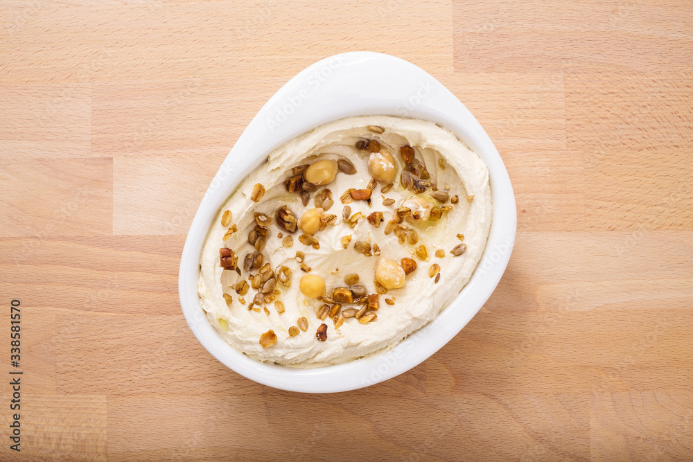Organic plant based hummus with granola and chick peas toppings. Perfect for vegan gluten free. Freshly homemade for takeaway and delivery. Healthy food photography. Organic plant based hummus with granola and chick peas toppings. Perfect for vegan gluten free. Freshly homemade for takeaway and delivery. Healthy food photography.