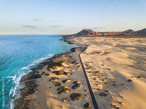 Aerial view of beautiful tropical beach and blue ocean landscape - heaven resort paradise concept for great sumer holiday vacation - tourism destination fuerteventura in spain canary islands photo