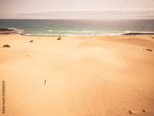 Fototapeta Naklejka Na Ścianę i Meble -  Aerial view of beautiful tropical beach and blue ocean landscape - heaven resort paradise concept for great sumer holiday vacation - tourism destination fuerteventura in spain canary islands