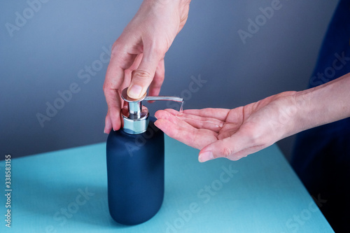Close up photography of female hands squeeze the soap on a light background. Bright color, minimal shot - an example of how need to wash and soap your hands