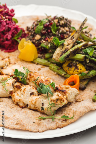 Grilled chicken tikka yoghurt with salad side dish. beetroot, asparagus, and quinoa. Perfect for healthy living vegetarian. Organic food photography concept.