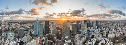 Aerial panoramic drone shot of La Defense skycraper in Paris CBD skyscraper complex business district with clouds during sunset photo