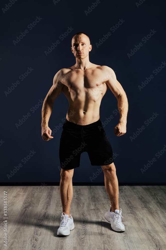 Bodybuilder demonstrates his muscles relief and strong arms, clear muscular ABS Bodybuilder demonstrates his muscles relief and strong arms, clear muscular ABS