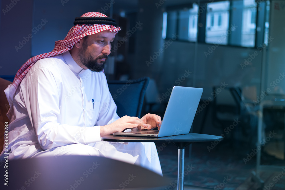 Middle Eastern businessman typing on the phone in his office. Businessman Arabic using mobile phone for connection to communication.Business Technology concept. Middle Eastern businessman typing on the phone in his office. Businessman Arabic using mobile phone for connection to communication.Business Technology concept.