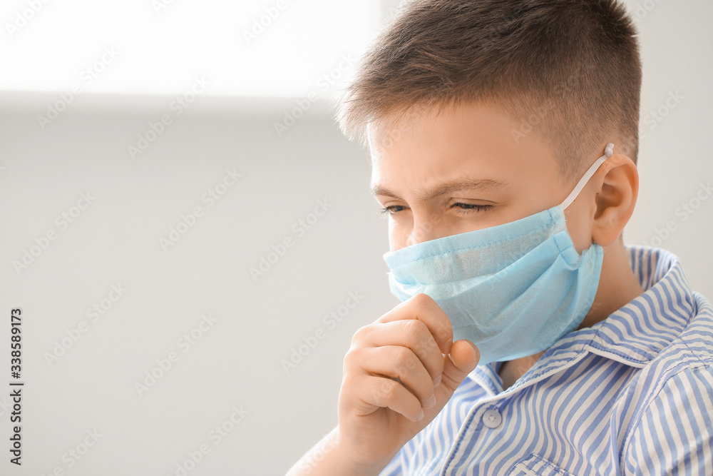 Ill little boy wearing protective mask at home. Concept of epidemic Ill little boy wearing protective mask at home. Concept of epidemic