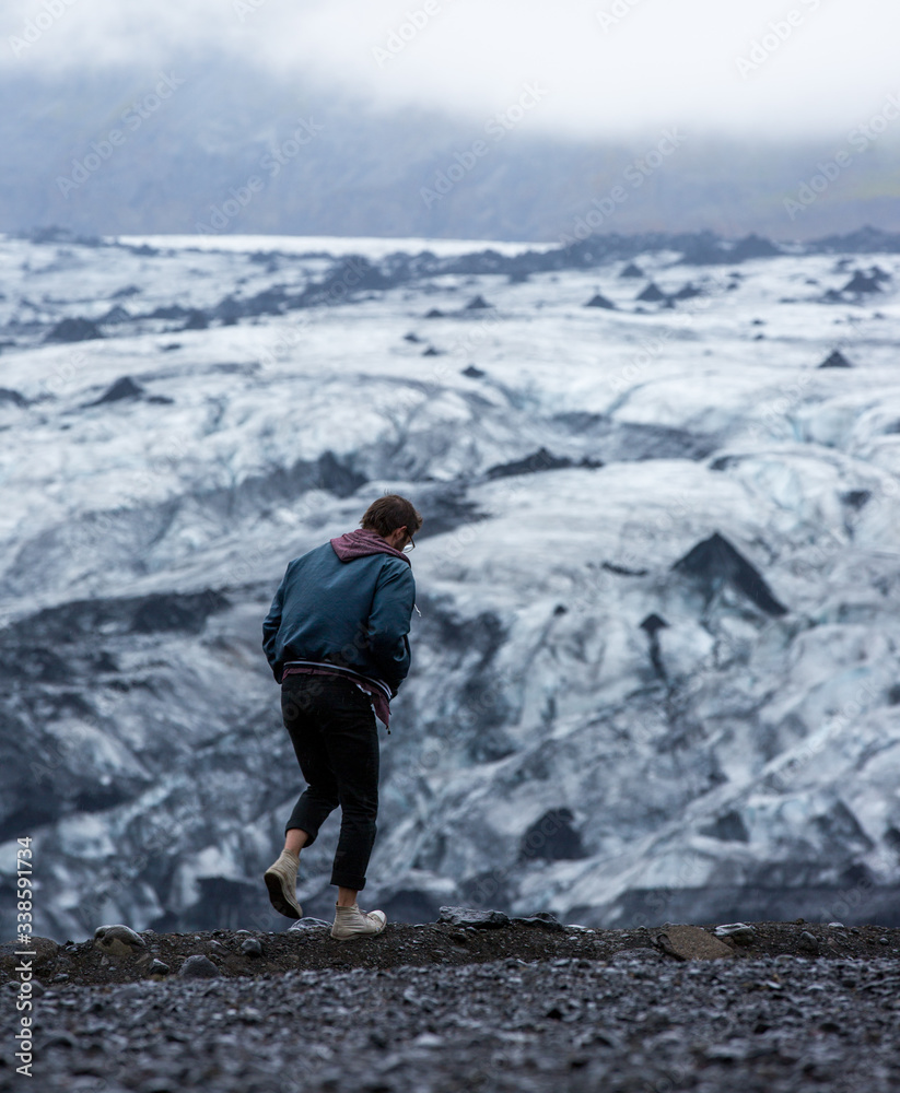Fototapeta premium model exploring foggy iceberg in Iceland, unusual unique landscape