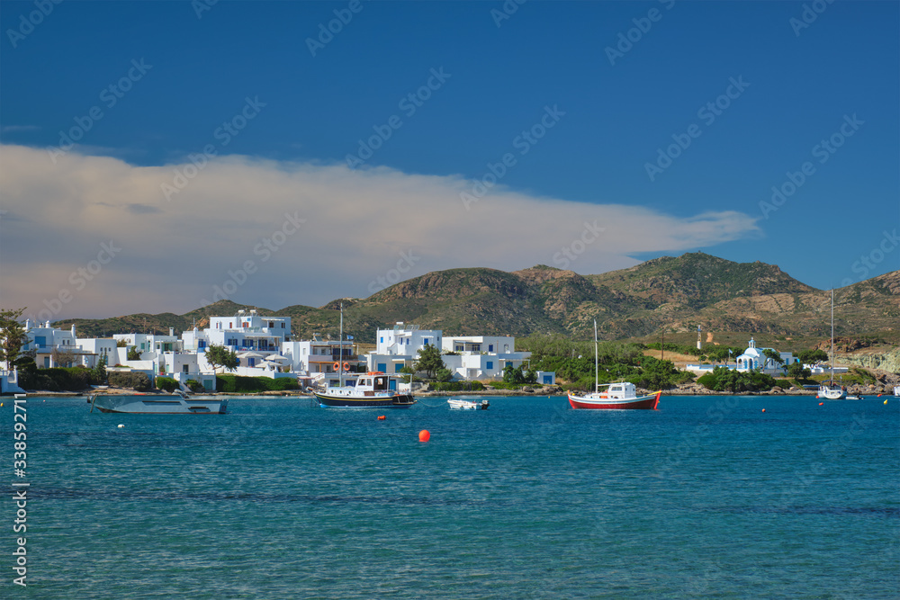 The beach and fishing village of Pollonia with fishing boats in sea. Pollonia town, Milos island, Greece