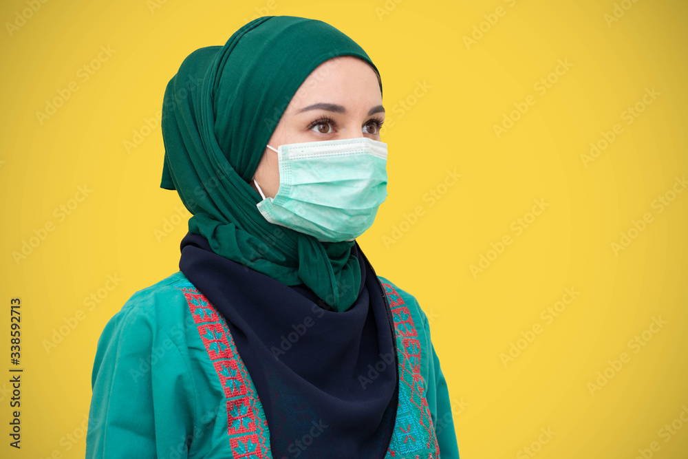 Muslim girl wearing surgical mask for protection. Hijab woman take a mask. muslim girl wearing mask for Muslim girl wearing surgical mask for protection. Hijab woman take a mask. muslim girl wearing mask for