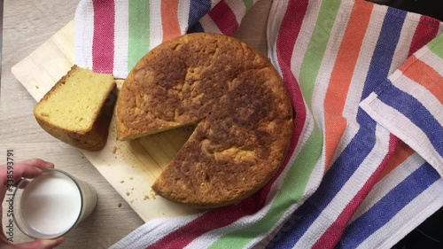 Appetizing and tasty homemade cake. Homemade pie. A piece of flavored cake. View from above. And a glass of milk for a wholesome and healthy breakfast.