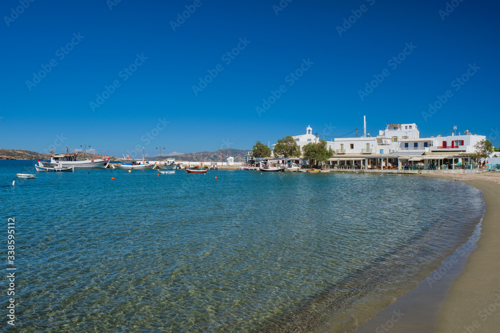 Fototapeta premium The beach and fishing village of Pollonia with fishing boats in sea. Pollonia town, Milos island, Greece