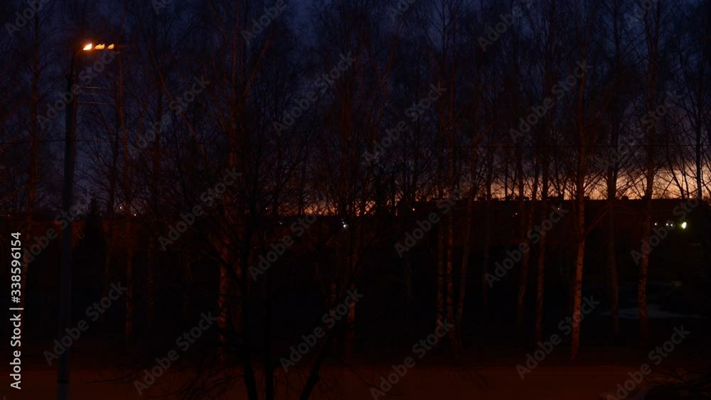 Timelapse of sunset in the city from the window of an apartment, dark and night