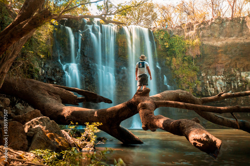 Person in amazing waterfall in the jungle of Costa Rica