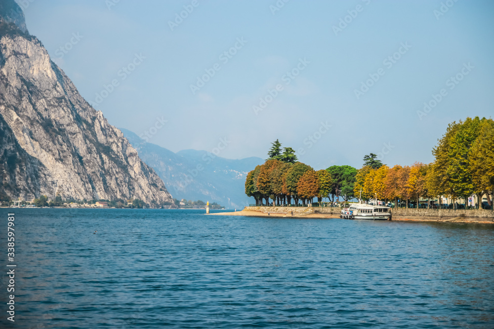 Sunny day on Lake Como and the small town of Lecco in Lombardy, Northern Italy. Italian traditional lake village, travel concept.