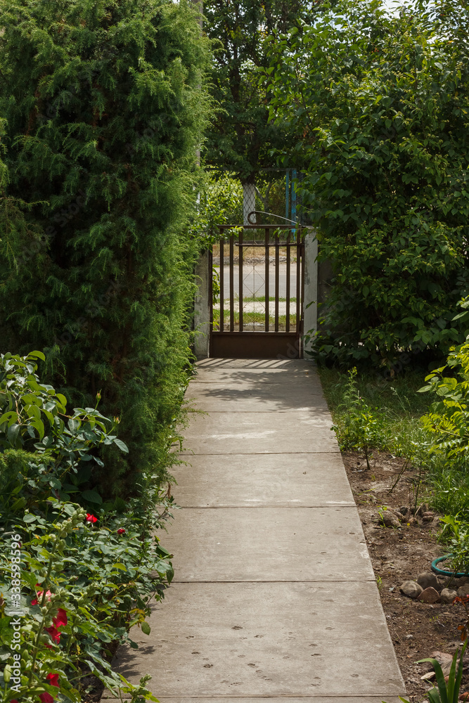 The concrete footpath leads to the gate. Private yard