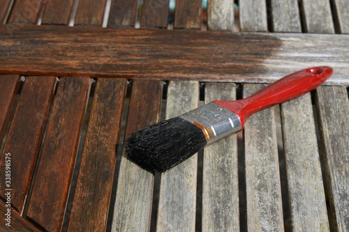 Paint brush painting wooden decking