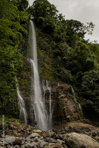 Man in a big waterfall in Bajos del Toro in Costa Rica