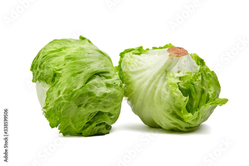 Iceberg lettuce isolated on white background. Two whole heads of crisphead lettuce, leafy green vegetables , selective focus