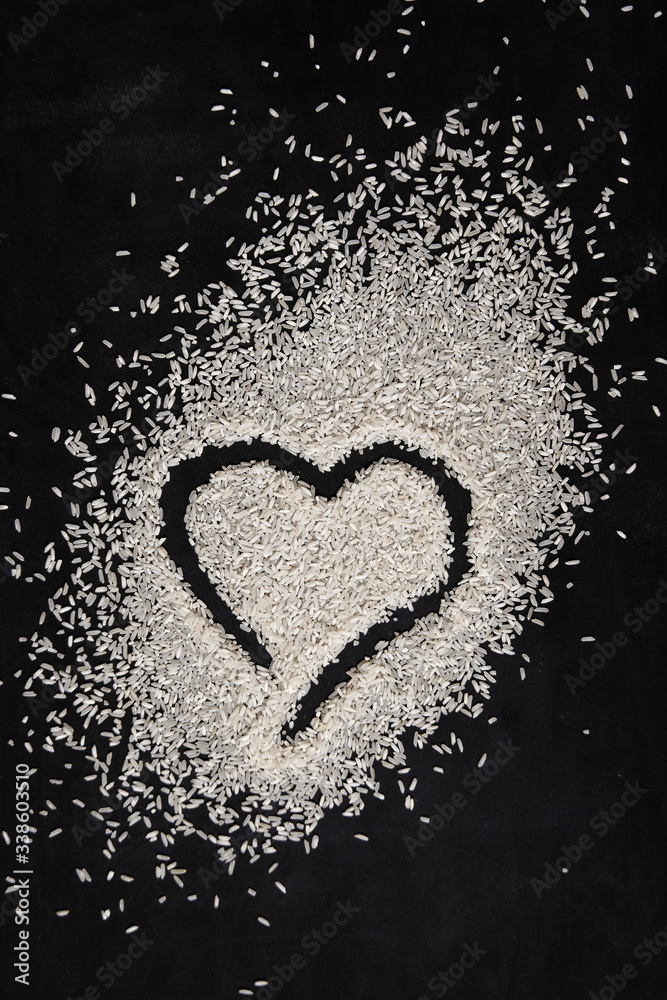 heart made of rice on dark background